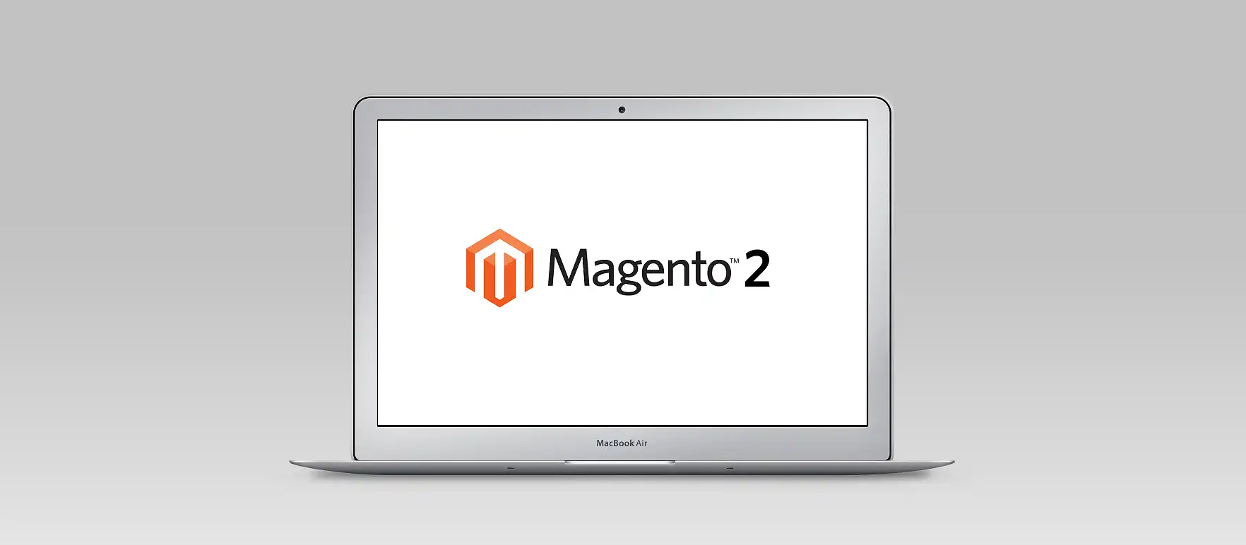Apple MacBook zeigt das Logo der Shopsoftware Magento 2